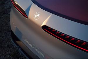 Eine Detailaufnahme des Hecks. Man sieht das BMW-Logo, die schmalen, horizontalen Rückleuchten und den Schriftzug "Neue Klasse".